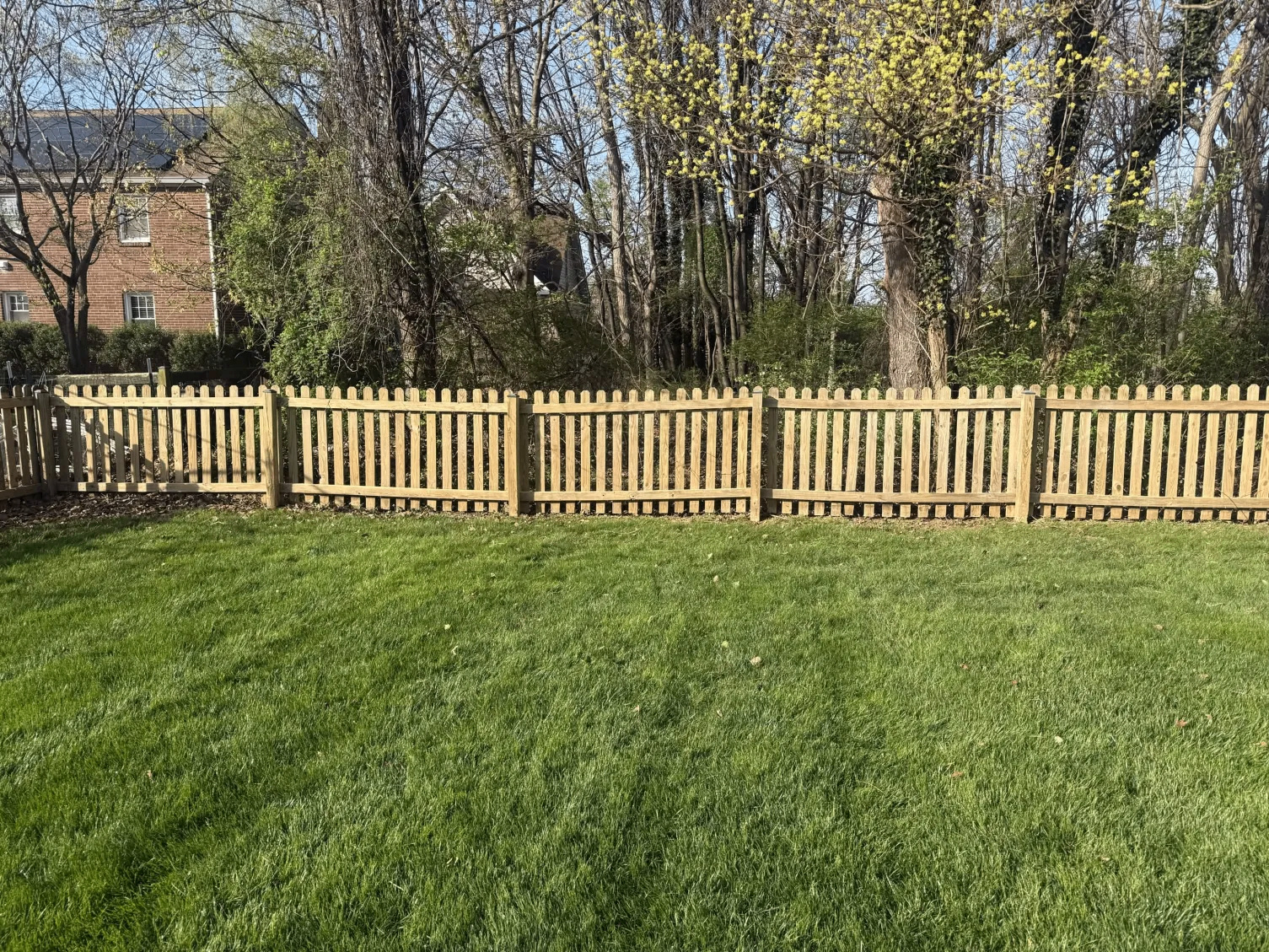 Clean wood fence after pressure washing